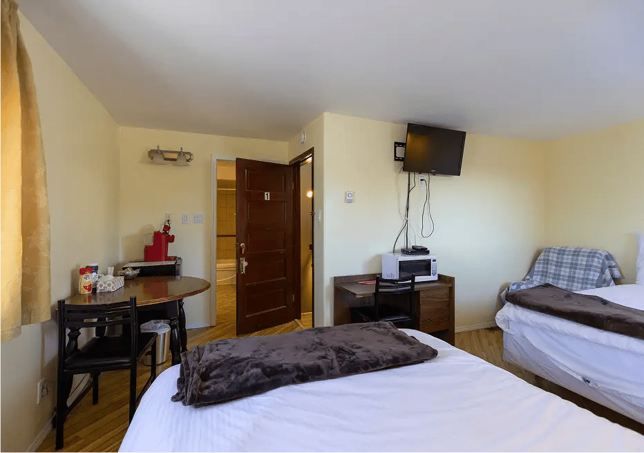 Two beds, old character flooring, TV, table and chairs, microwave.