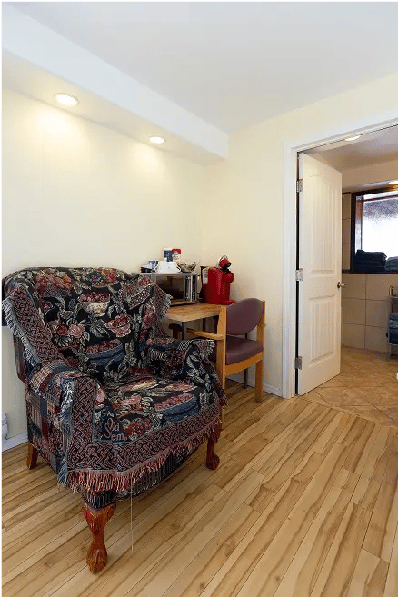 Old cozy chair, table, microwave.