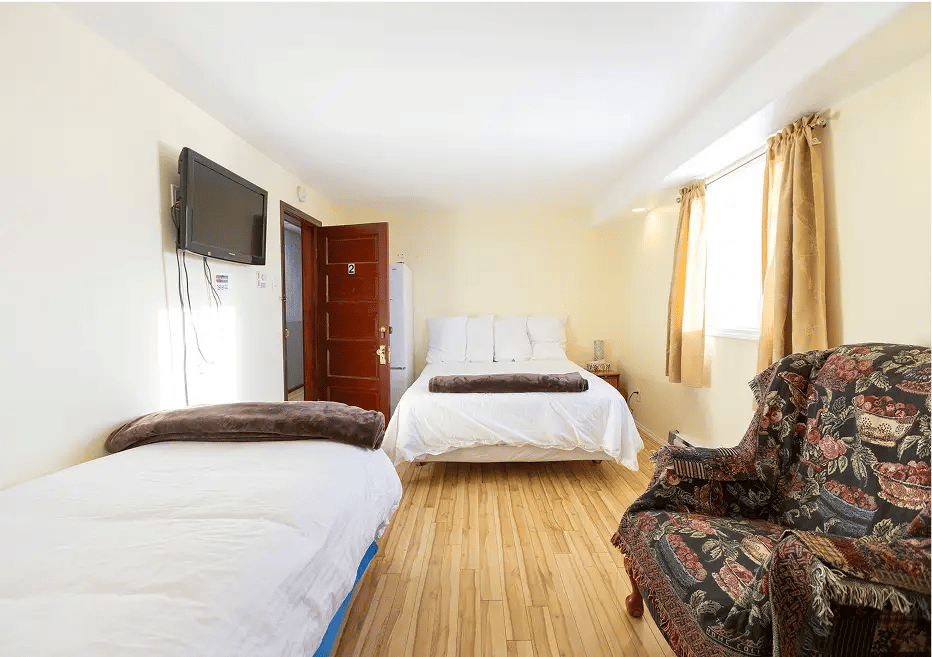 Smaller room, two beds, old cozy chair.